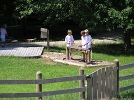 Kids playing a wooden marimba